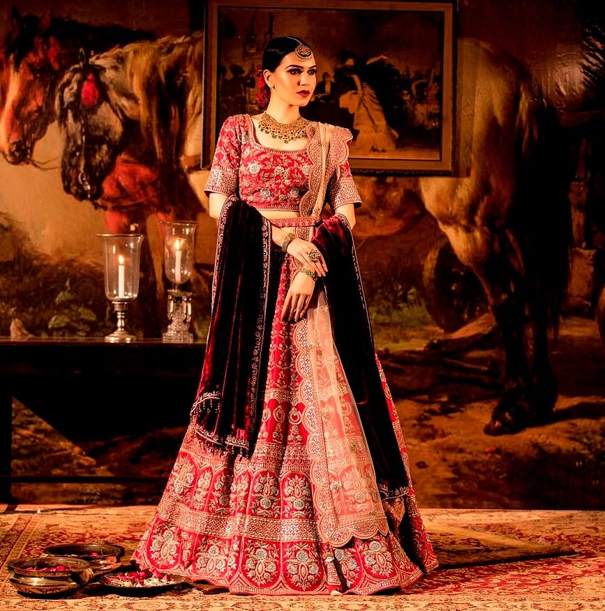 Photo of Bride Posing in Bright Red and Gold Bridal Lehenga